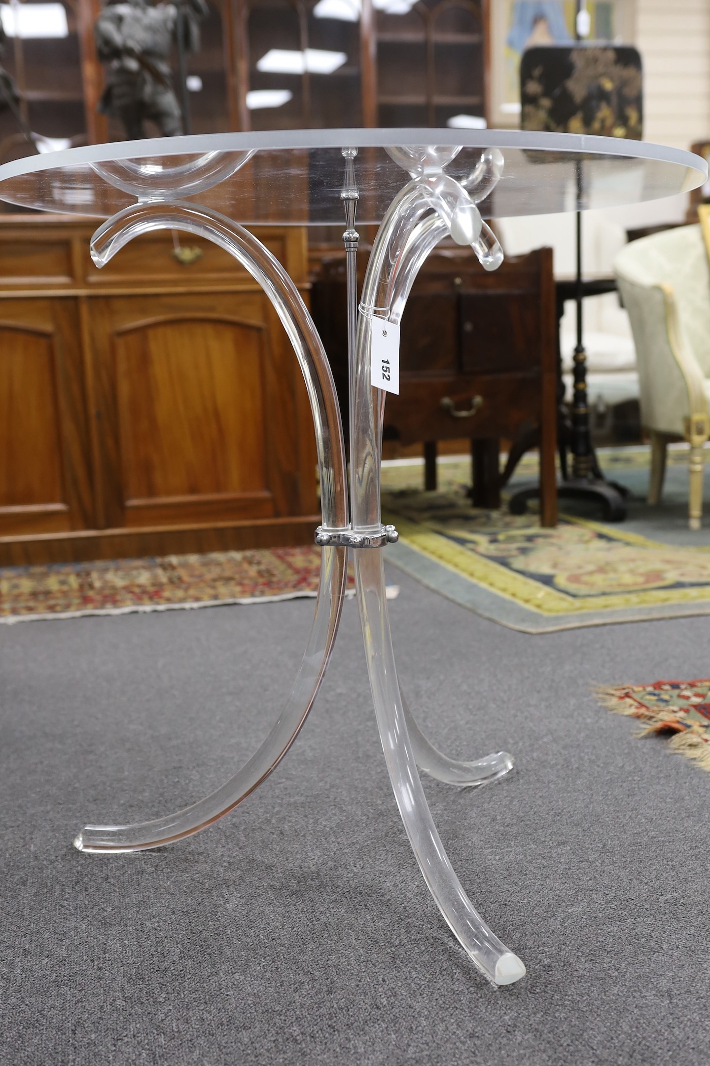 A Charles Hollis Jones style circular lucite tripod table, diameter 67cm, height 69cm
